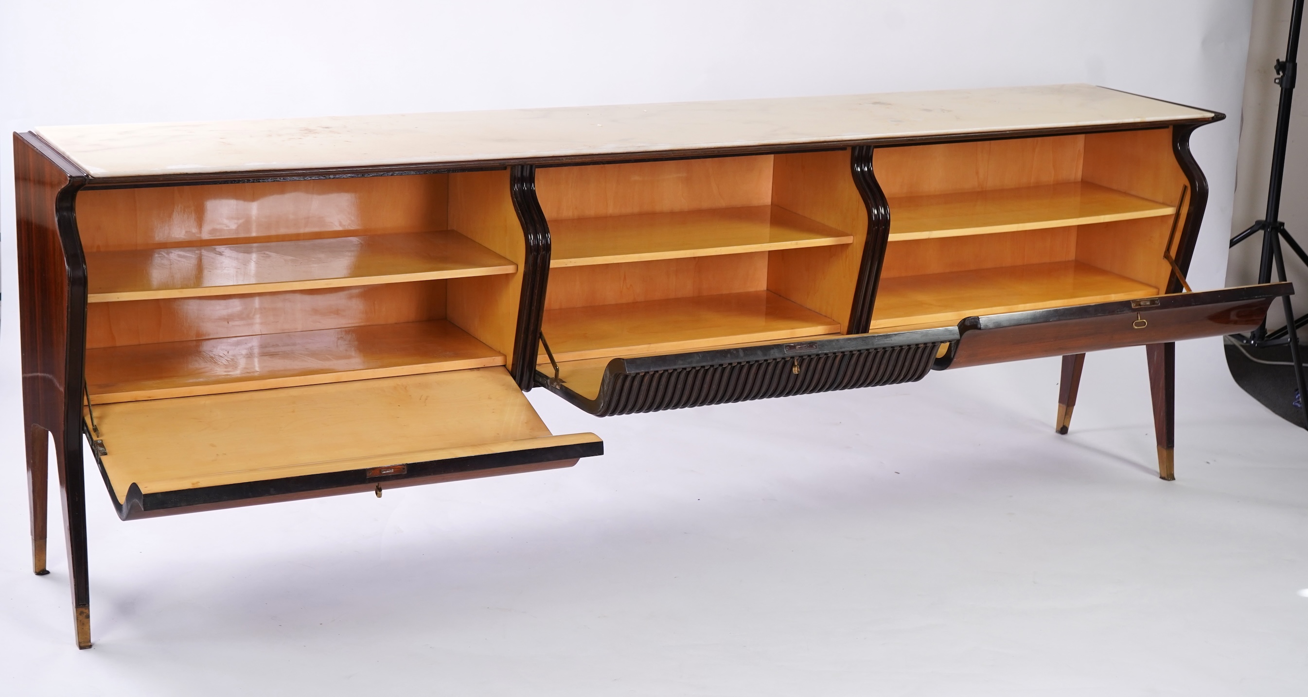 Osvaldo Borsani (Italian, 1911-1985) for Atelier Borsani Varedo: A large Indian rosewood and mahogany credenza, 276.5cm wide x 49cm deep x 94cm high